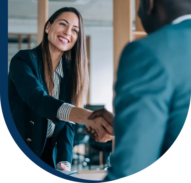 A smiling woman shaking hands with a man.